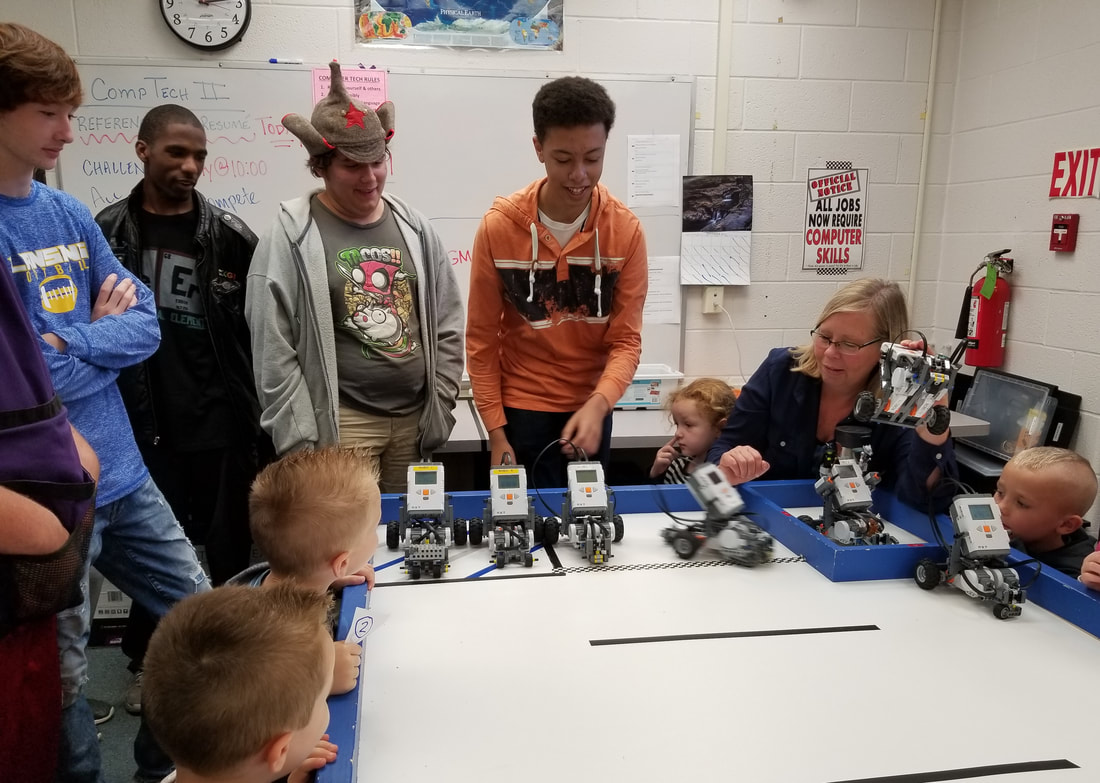 computer science students teaching little kids robots Picture